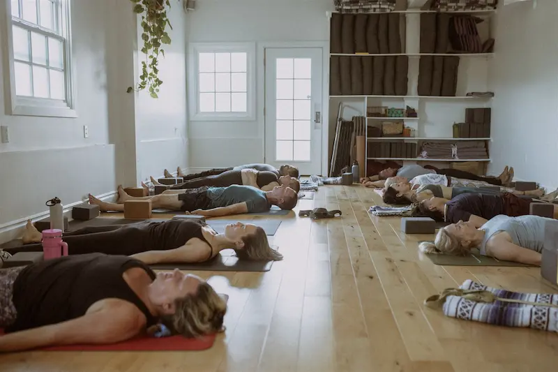 Students resting in a restorative Connected Warriors class