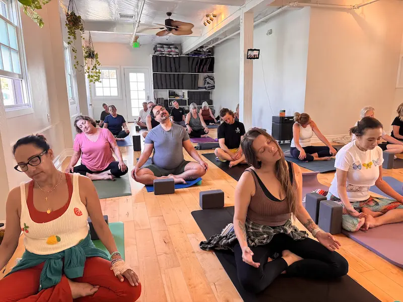 Students seated in a Roll & Recover class using blocks and props